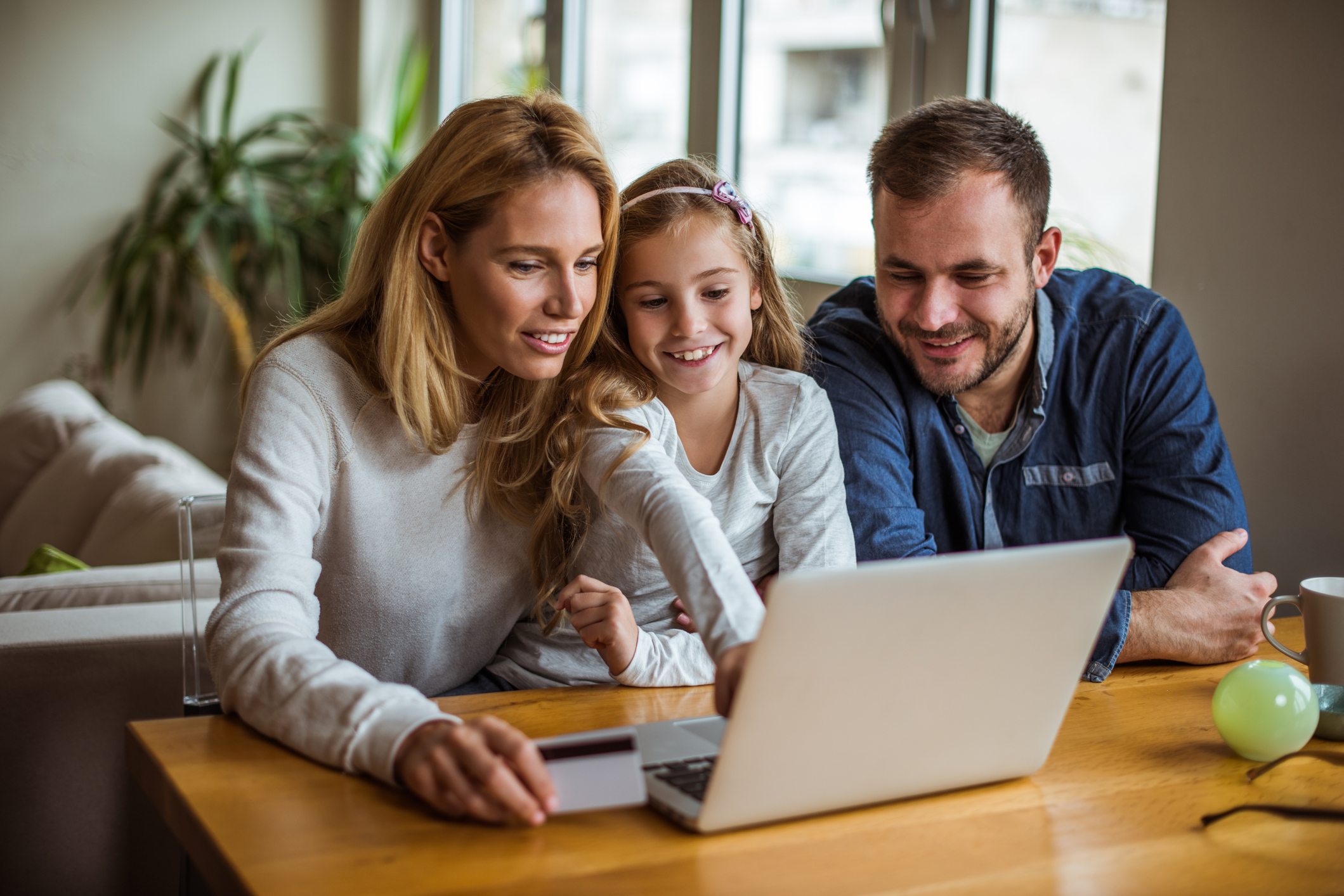 Family looking at laptop together using Internet from a service provider in Lafourche