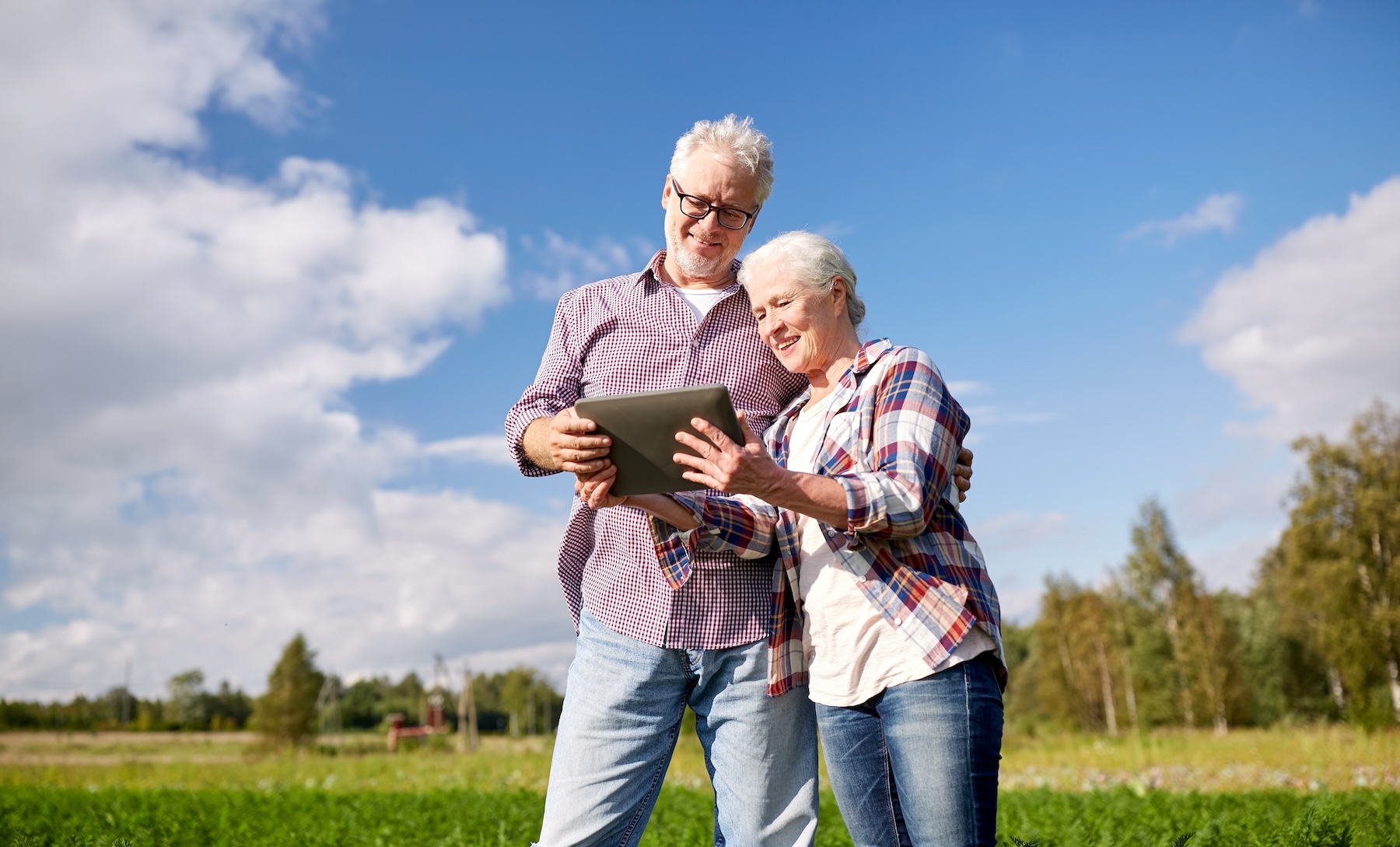 REV Business 2 October Senior couple looking at tablet together on their farm