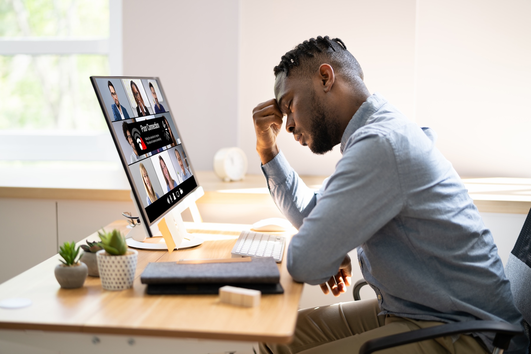 REV Business 2 October Remote worker frustrated with slow home Internet during a video call