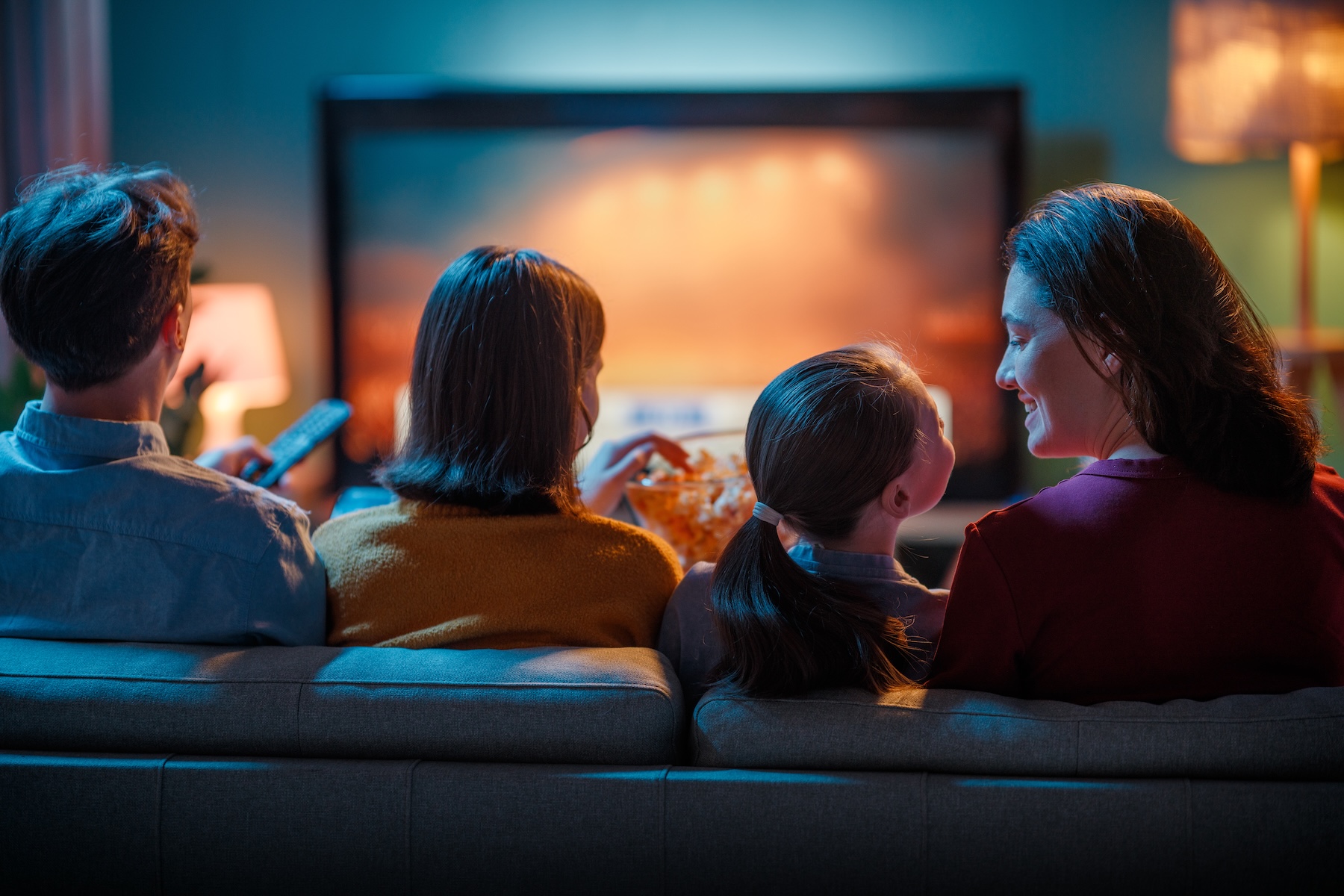 Happy family spending time together watching TV at home